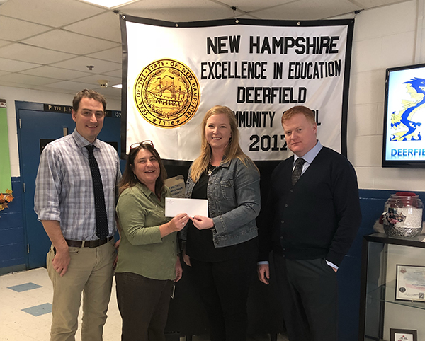 Agent Kelly Williams delivers donation check to Deerfield Community School