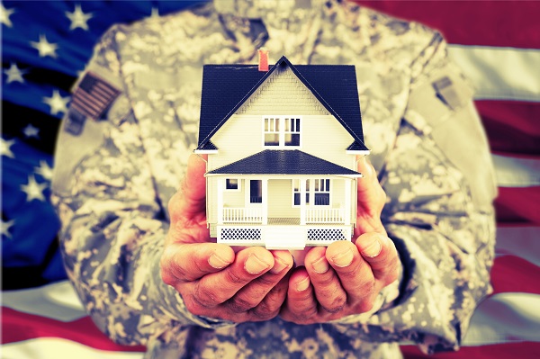 soldier holding small model house