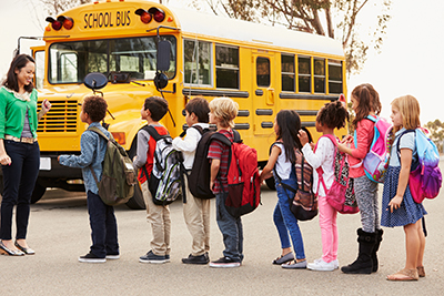 kids in front of school bus