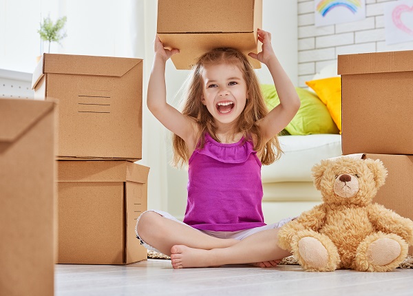 little girl playing with moving boxes