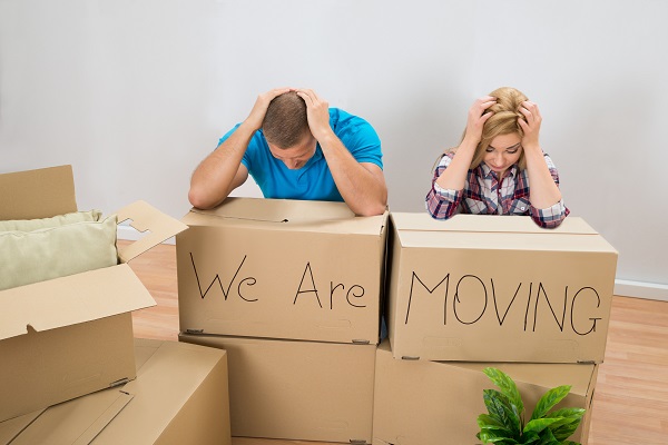 stressed couple with moving boxes