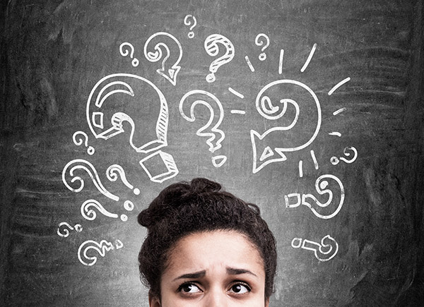 Woman with confused look and question marks around head